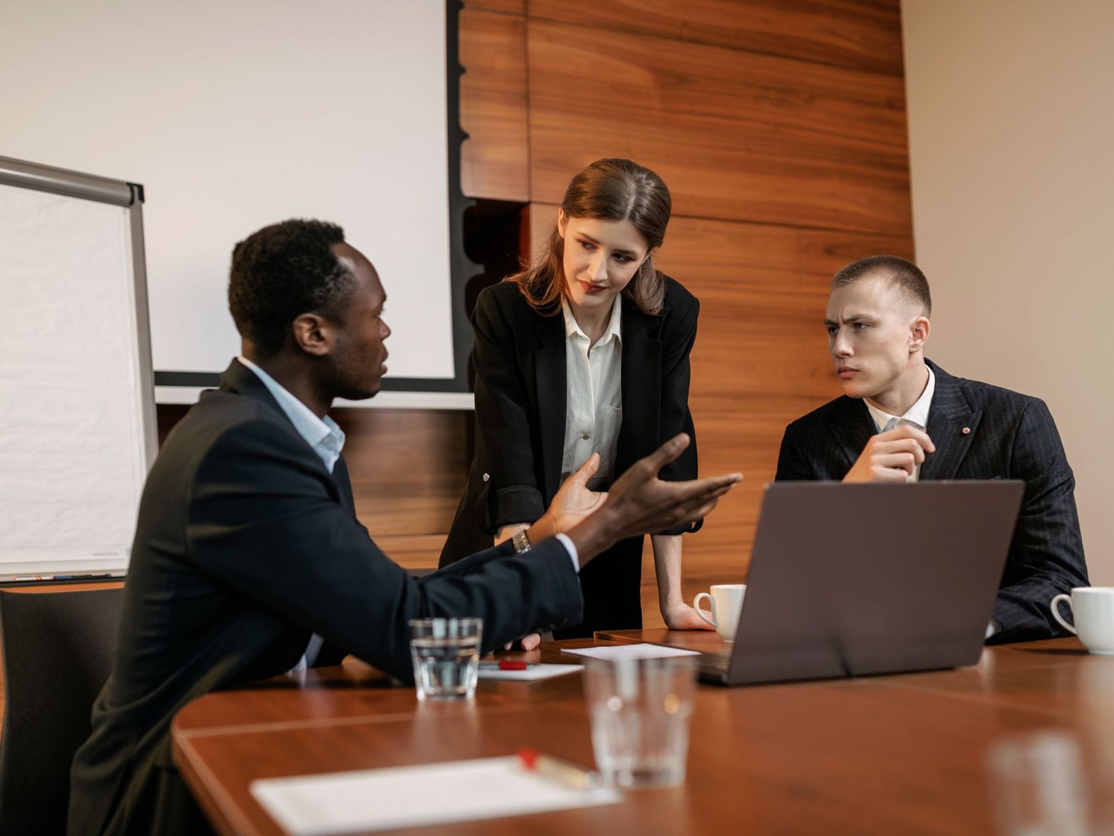 A neutral, professional HR meeting with colleagues seated around a table